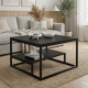 The coffee table is two-level black with a metal frame